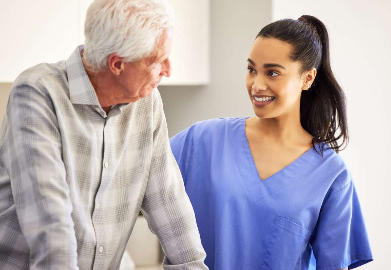 Personal Support Worker Program student assisting elderly man at home